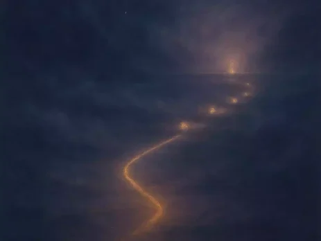 A twilight pathway of soft golden light forming through mist, with small glowing points suggesting gradual progress between casting and manifestation.