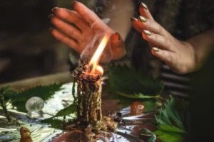 Return Lost Lover Spell ritual with a burning candle, spiritual energy work, and focused hands guiding the flame.