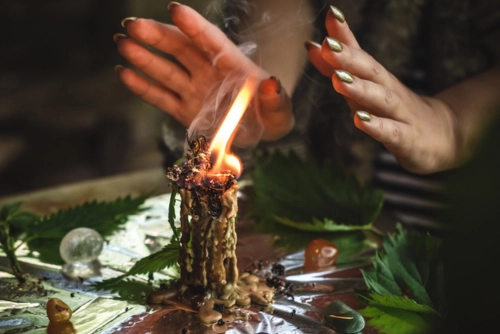Return Lost Lover Spell Ritual Candle Return Lost Lover Spell ritual with a burning candle, spiritual energy work, and focused hands guiding the flame.